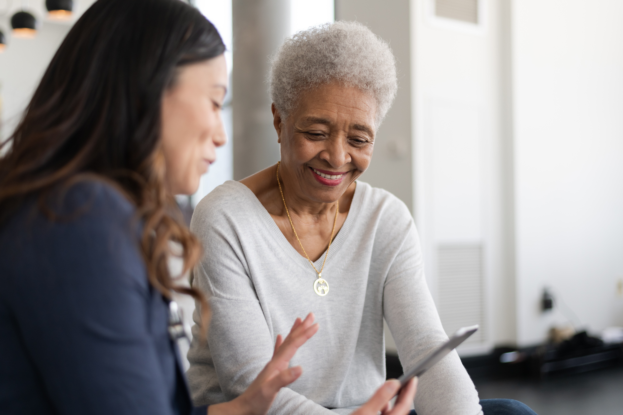 A case manager and older adult woman working together.
